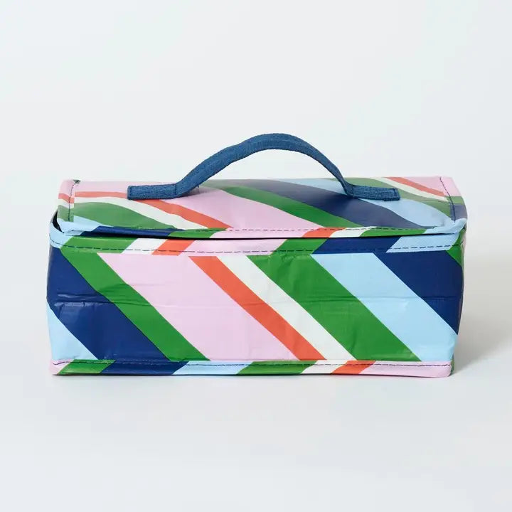 Colorful geometric-patterned box with a handle on a white background