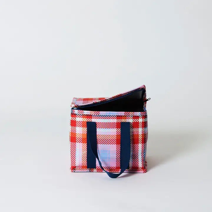 Plaid patterned bag with a black strap on a white background