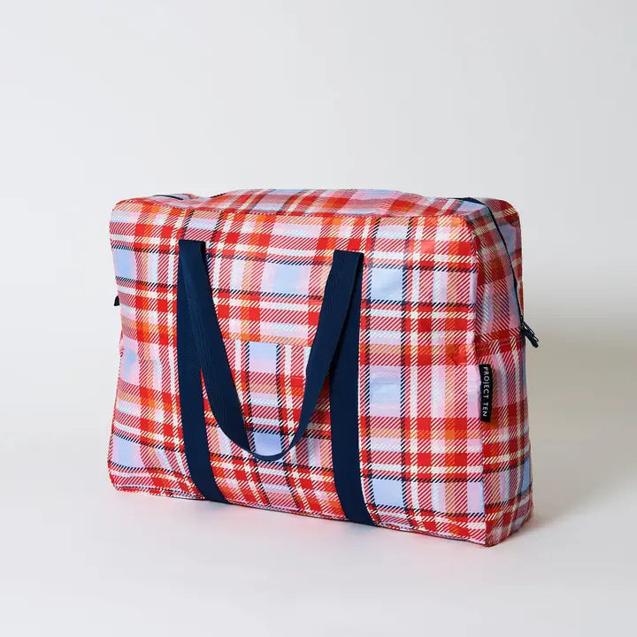 Plaid bag with blue handles on a white background