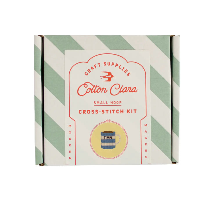 Cotton Clara cross-stitch kit box with green and white striped design on a white background