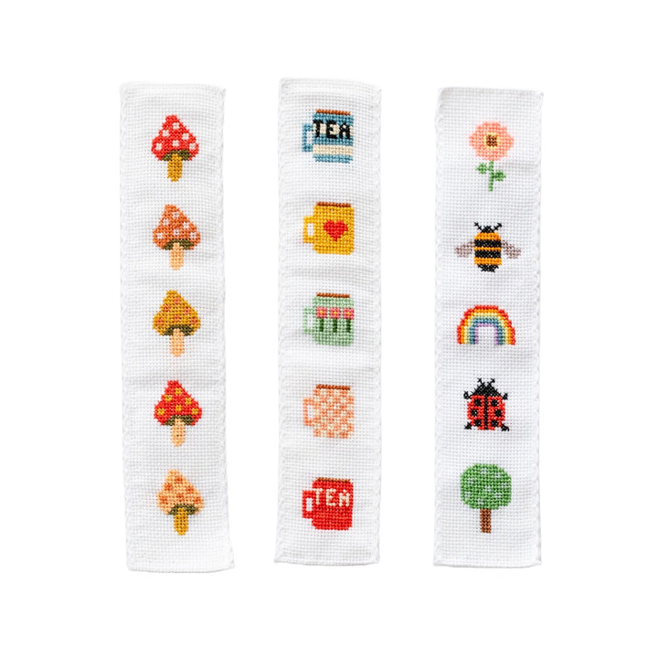 Three cross-stitched bands with various icons on a white background