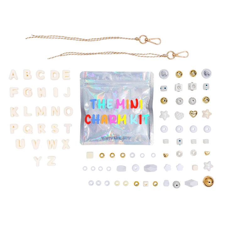 Mini charm kit with various charms and a clear bag labeled &