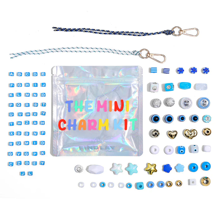 Mini charm kit with various charms and packaging on a white background