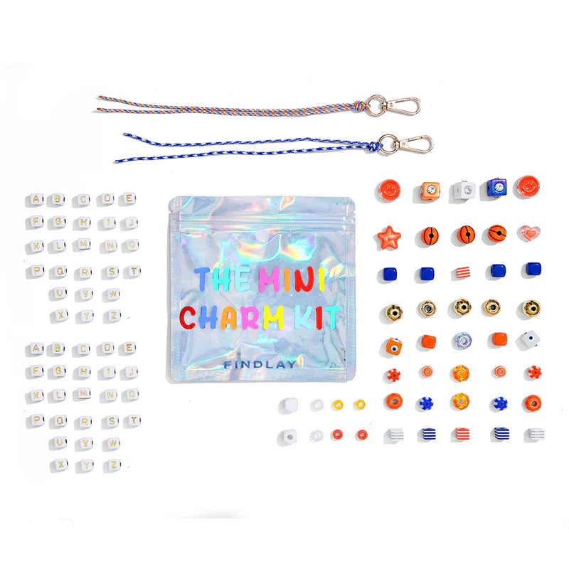 Mini charm kit with various charms and packaging on a white background