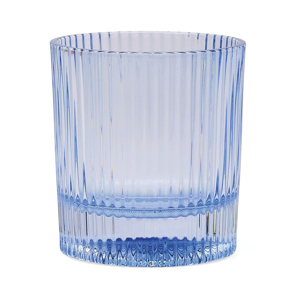 Blue glass tumbler with textured design on a white background