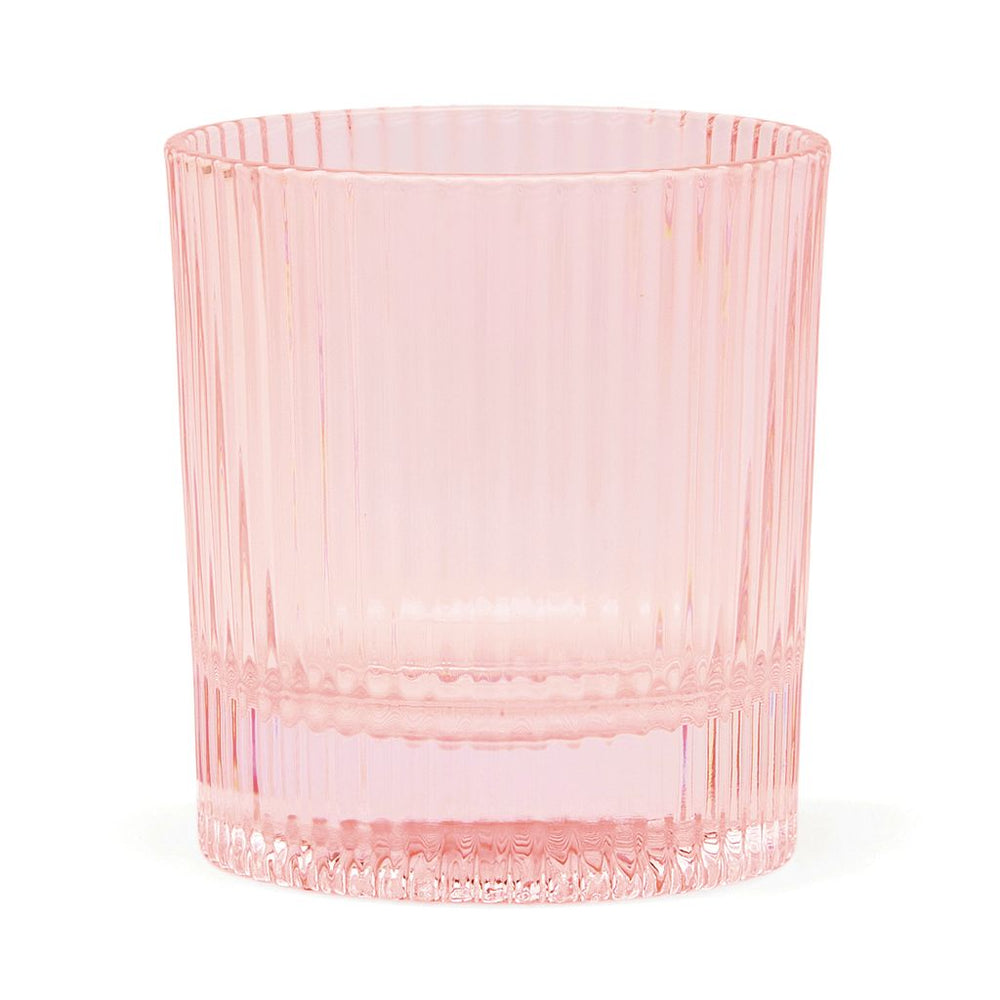 Pink glass tumbler with ribbed texture on a white background