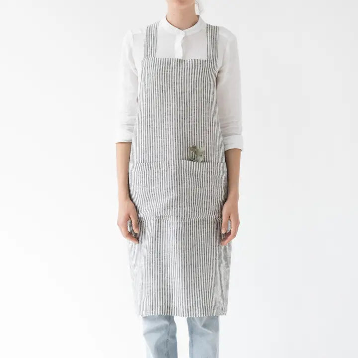 Person wearing a striped apron on a white background