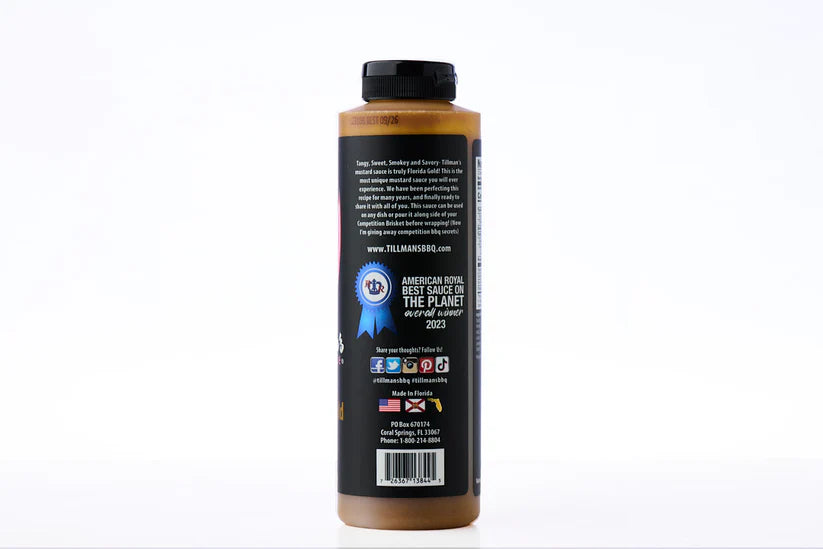 Bottle of sauce with a black label on a white background