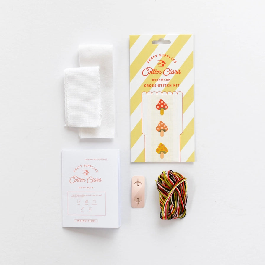 Cross-stitch kit with materials on a white background
