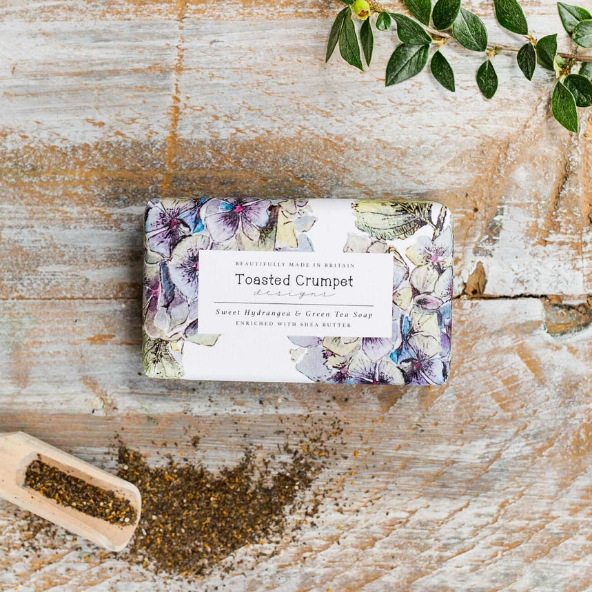 Bar of soap with a floral label on a wooden surface