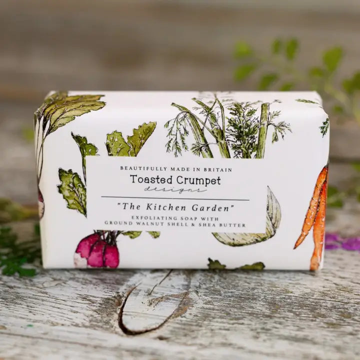 Bar of soap with 'The Kitchen Garden' design on a wooden surface