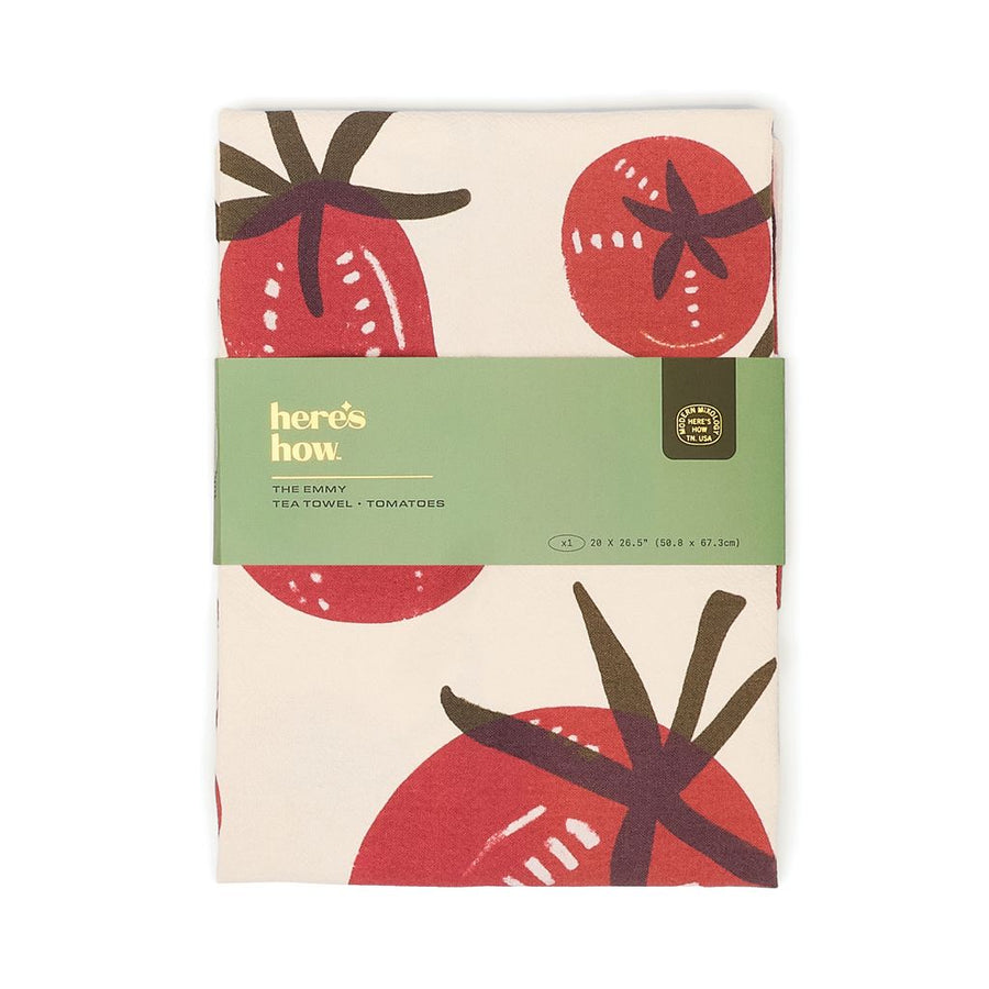 Packaged towel with tomato design and 'here's how' branding on a white background