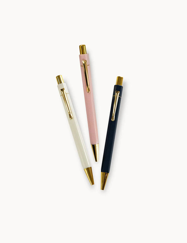 Three pens in white, pink, and black with gold accents on a white background