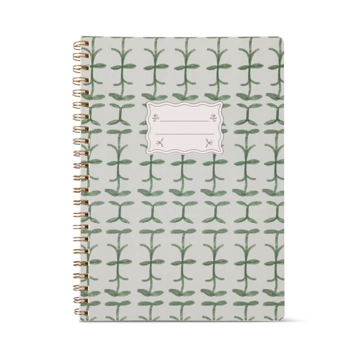 Notebook with green leaf pattern on a white background