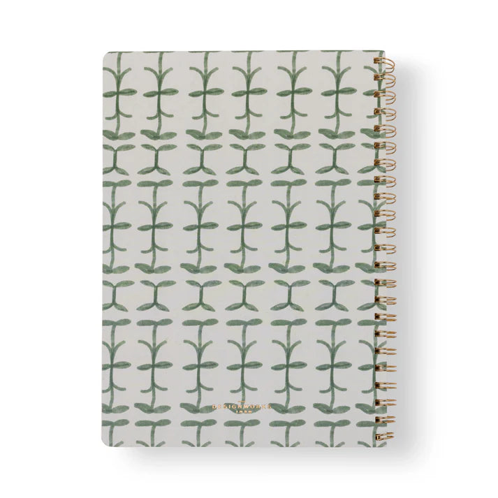 Notebook with green leaf pattern on a white background