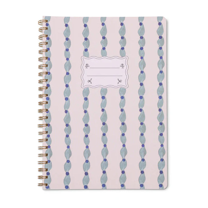 Notebook with spiral binding and decorative cover on a white background