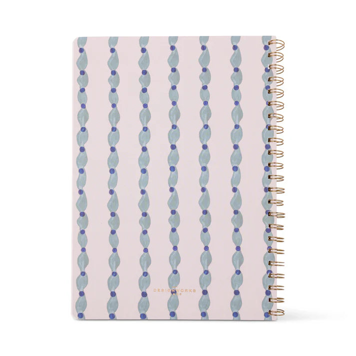 Notebook with blue and green pattern on a white background