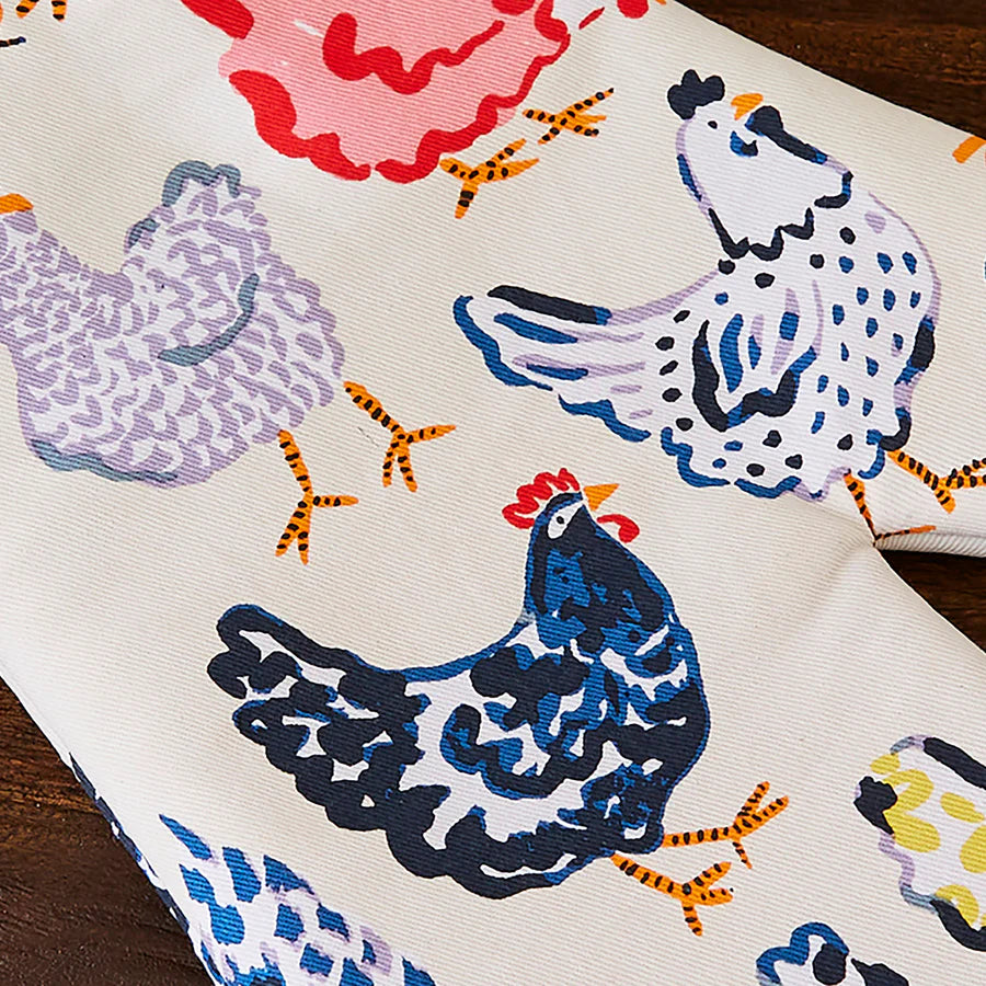 Colorful fabric with chicken patterns on a wooden surface
