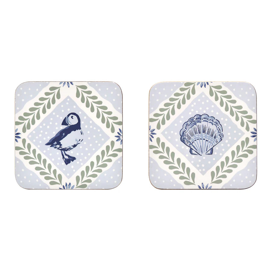 Two square coasters with nature-themed designs on a white background