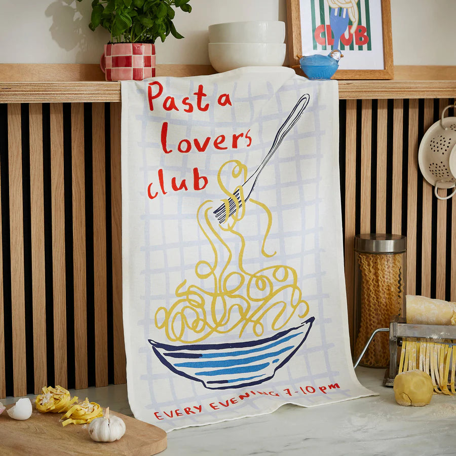 Tea towel with 'Pasta lovers club' design on a kitchen counter.