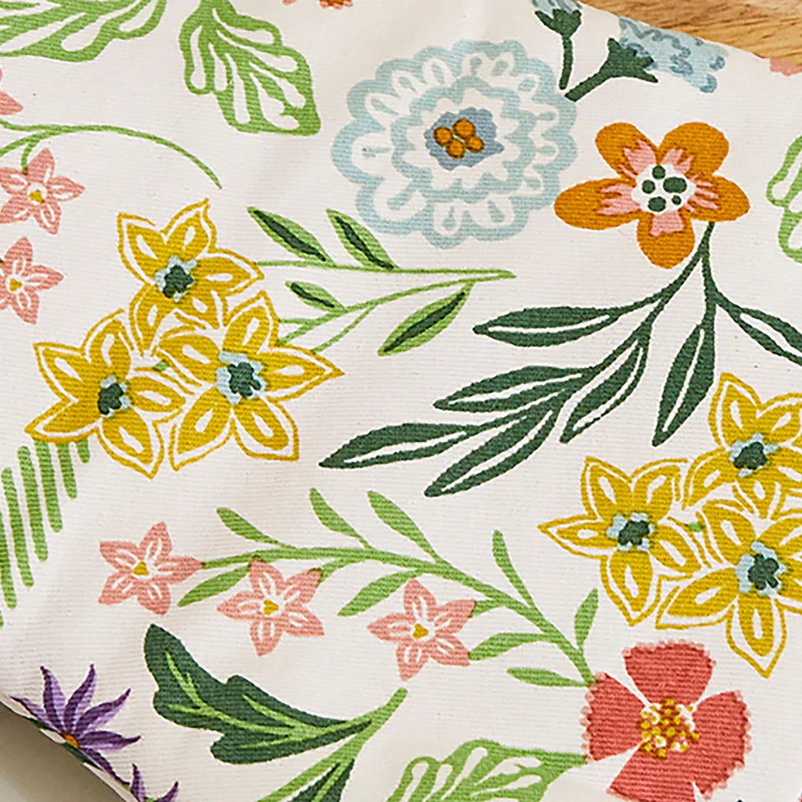 Floral patterned fabric with colorful flowers and leaves on a white background