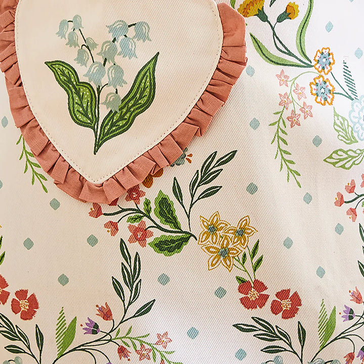 Heart-shaped embroidered fabric with floral patterns on a matching fabric background