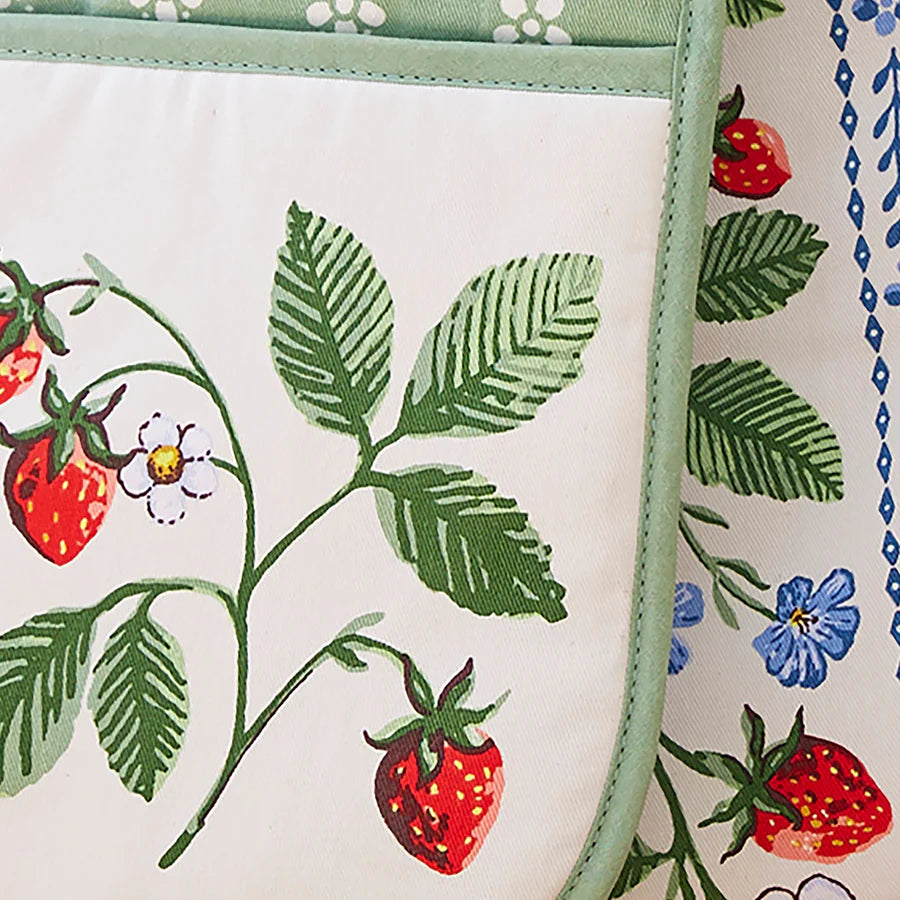 Close-up of a fabric with strawberry and leaf pattern on a white background