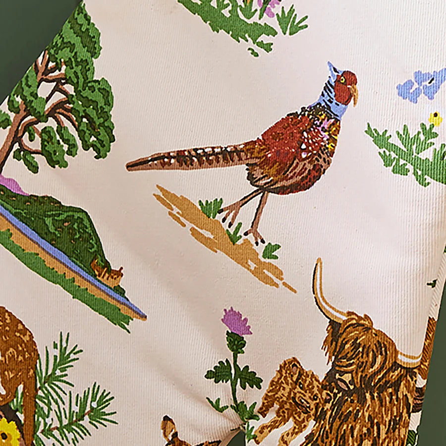 Patterned fabric with animals and nature elements on a beige background