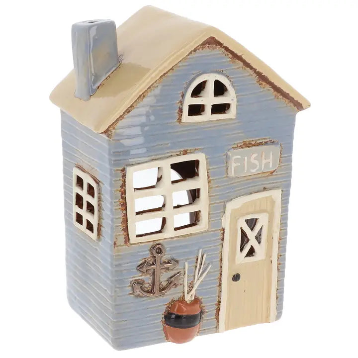 Decorative miniature house  tealight holder  with 'Fish' sign and anchor detail  on a white background