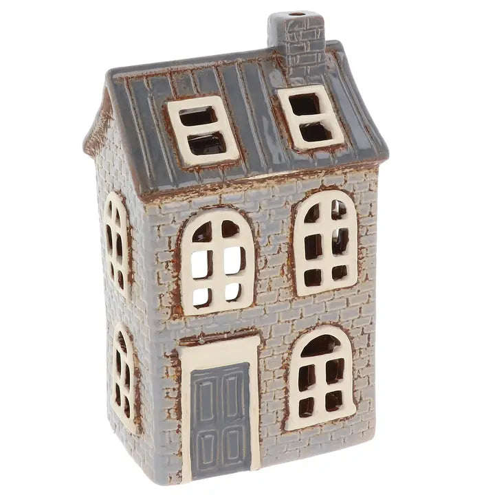 Decorative house-shaped tealight holder with a gray roof and white walls on a white background
