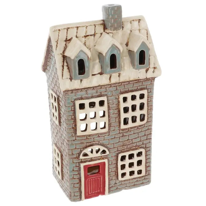 Decorative house-shaped tealight holder with a red door on a white background