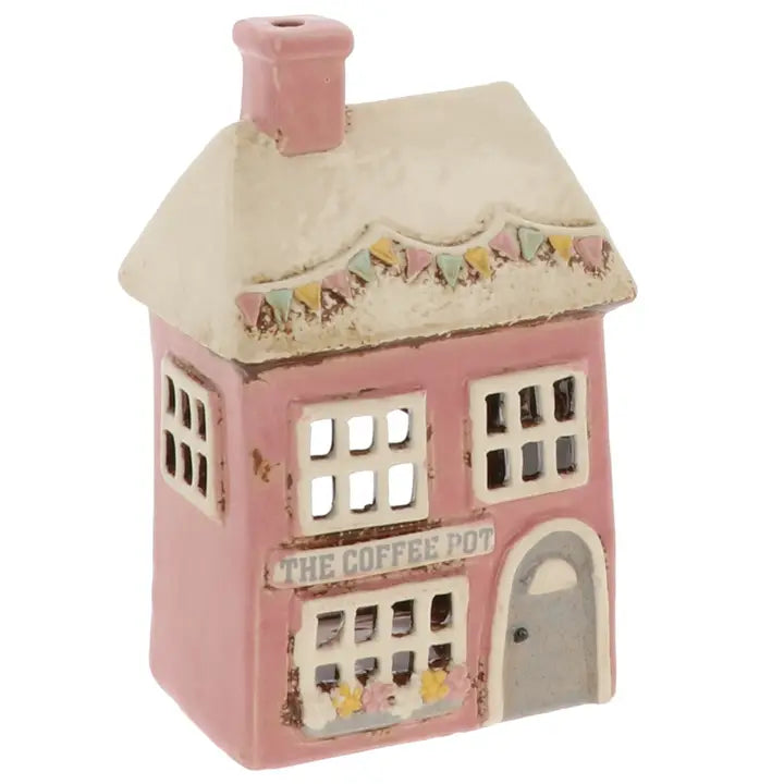 Decorative house-shaped tealight holder with 'The Coffee Pot' text on a white background