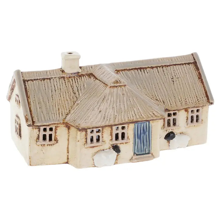 Ceramic house tealight holder on a white background