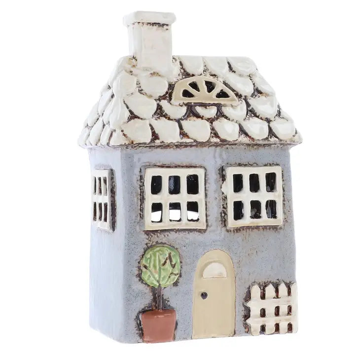Ceramic house tealight holder on a white background