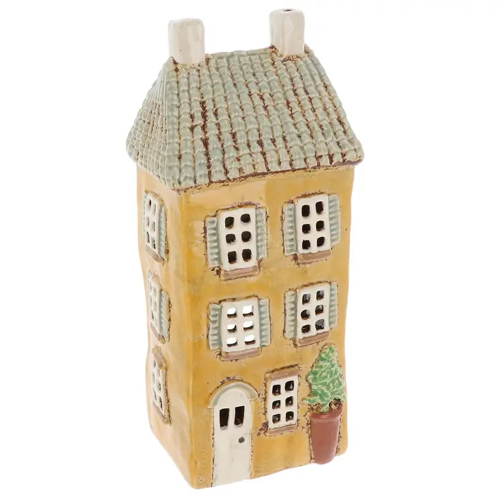 Ceramic house tealight holder with a textured roof on a white background