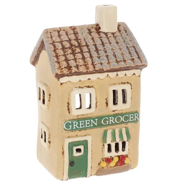 Ceramic house tea light holder on white background