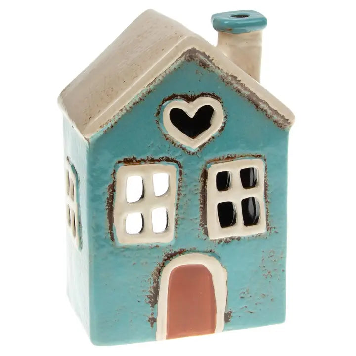 Ceramic house tealight holder with a heart window on a white background