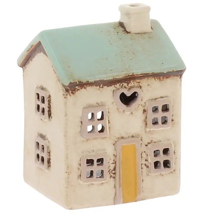 Ceramic house-shaped tealight holder with a green roof and white base on a white background