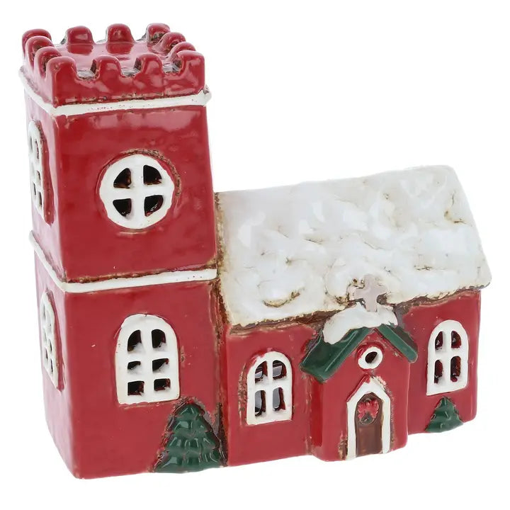 Red ceramic church tealight holder with a snowy roof on a white background