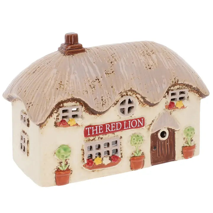 Ceramic tealight holder of a British pub on a white background