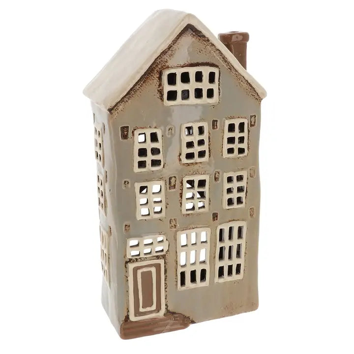 Ceramic house-shaped tealight holder with a white roof and brown body on a white background