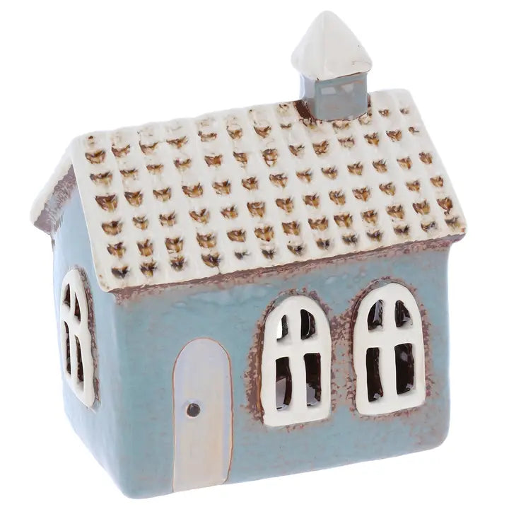 Ceramic house-shaped tealight holder with a patterned roof on a white background