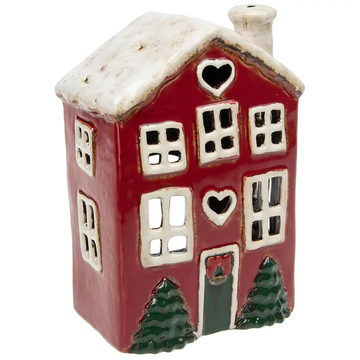 Red ceramic tealight house with white accents and snow on top, on a white background