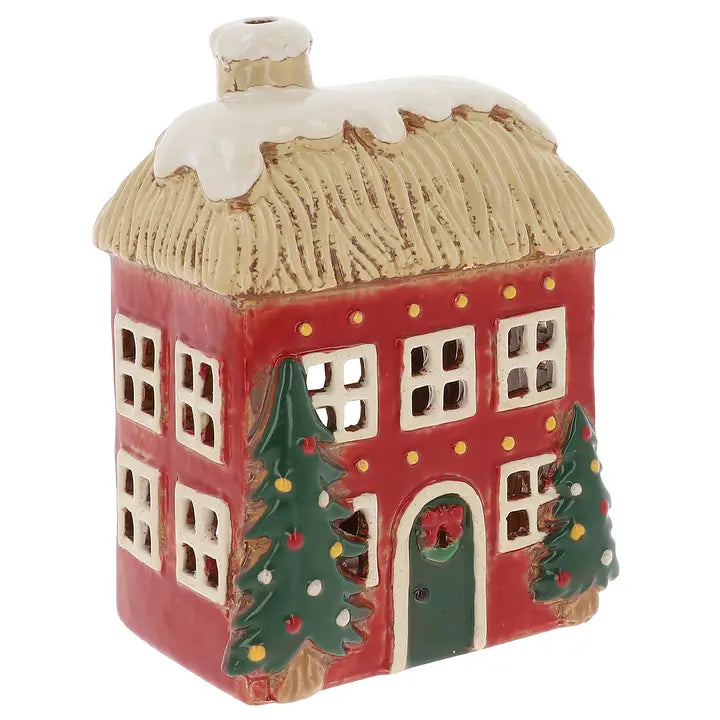 Decorative ceramic tealight house with Christmas trees on a white background