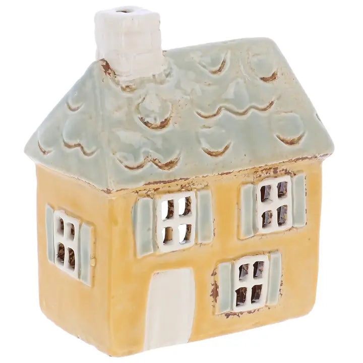 Ceramic house tealight holder on white background