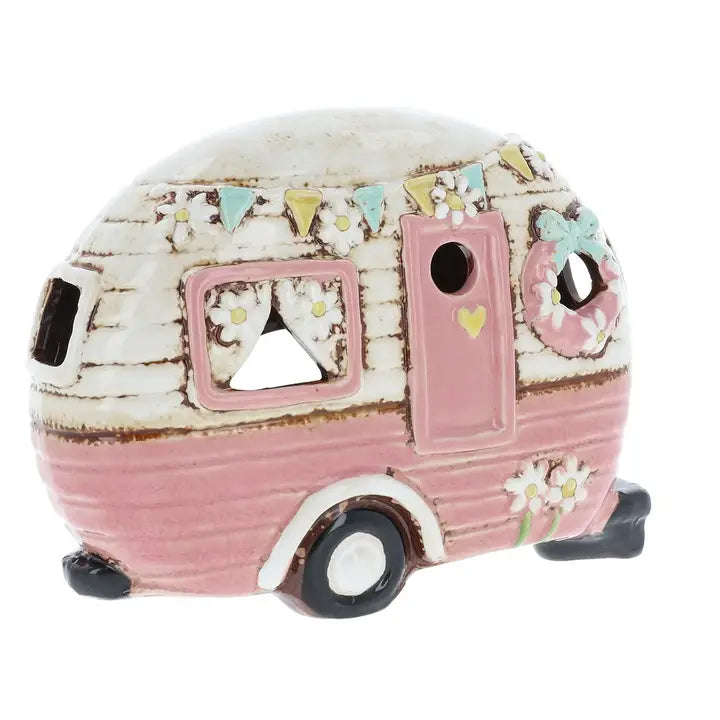 Decorative pink camper  tealight holder  with floral details on a white background