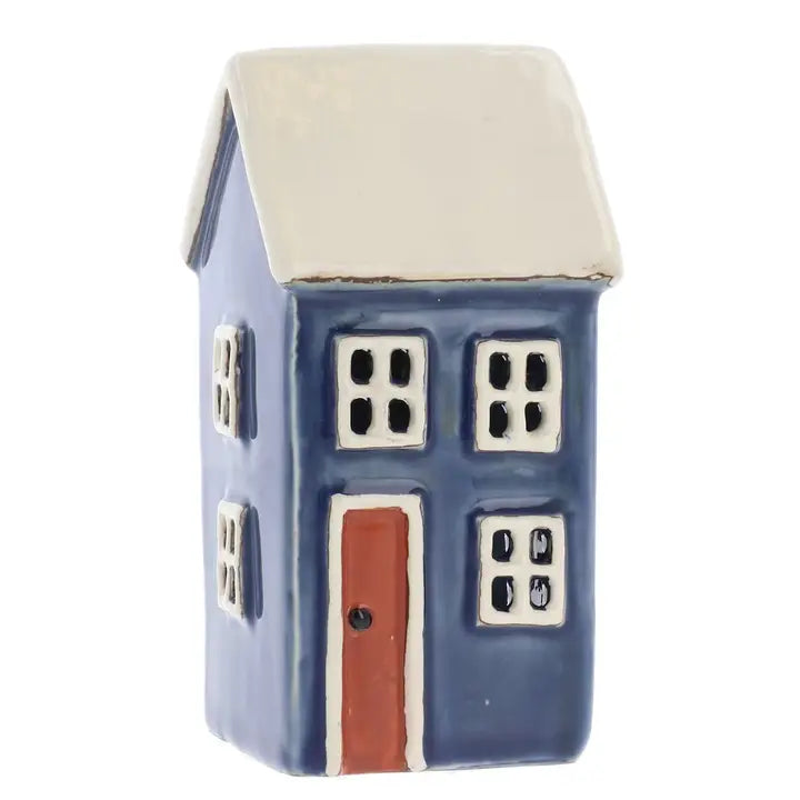 Small ceramic house tealight holder with a blue body, beige roof, and red door on a white background