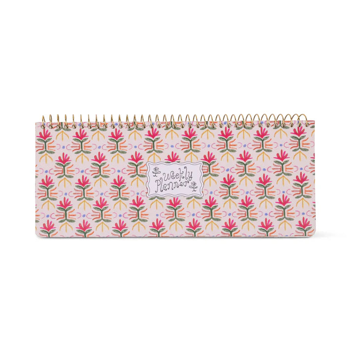 Floral patterned desk calendar with 'Weekly Planner'  on it on a white background