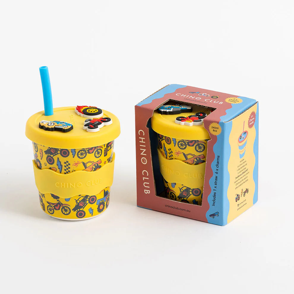 Yellow cup with motorcycle design and blue straw next to its packaging on a white background