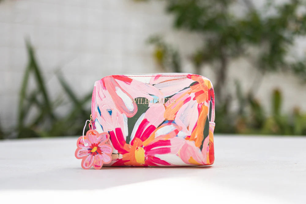 Floral patterned cosmetic bag on a white surface
